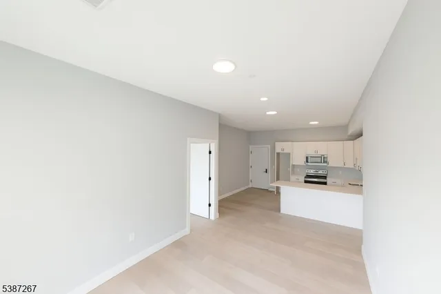 a view of a kitchen with a sink and cabinets