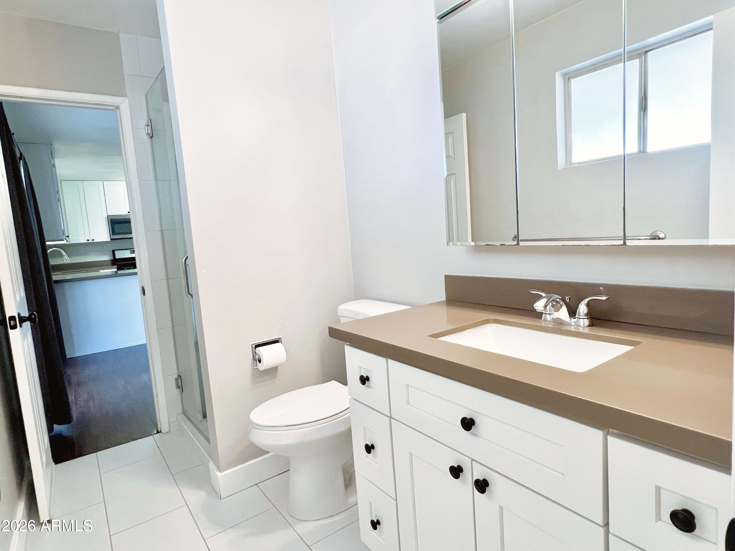 1220 West Romo Jones Street Tempe, AZ 85281 - Photo 22 of 26 a bathroom with a granite countertop sink toilet and mirror