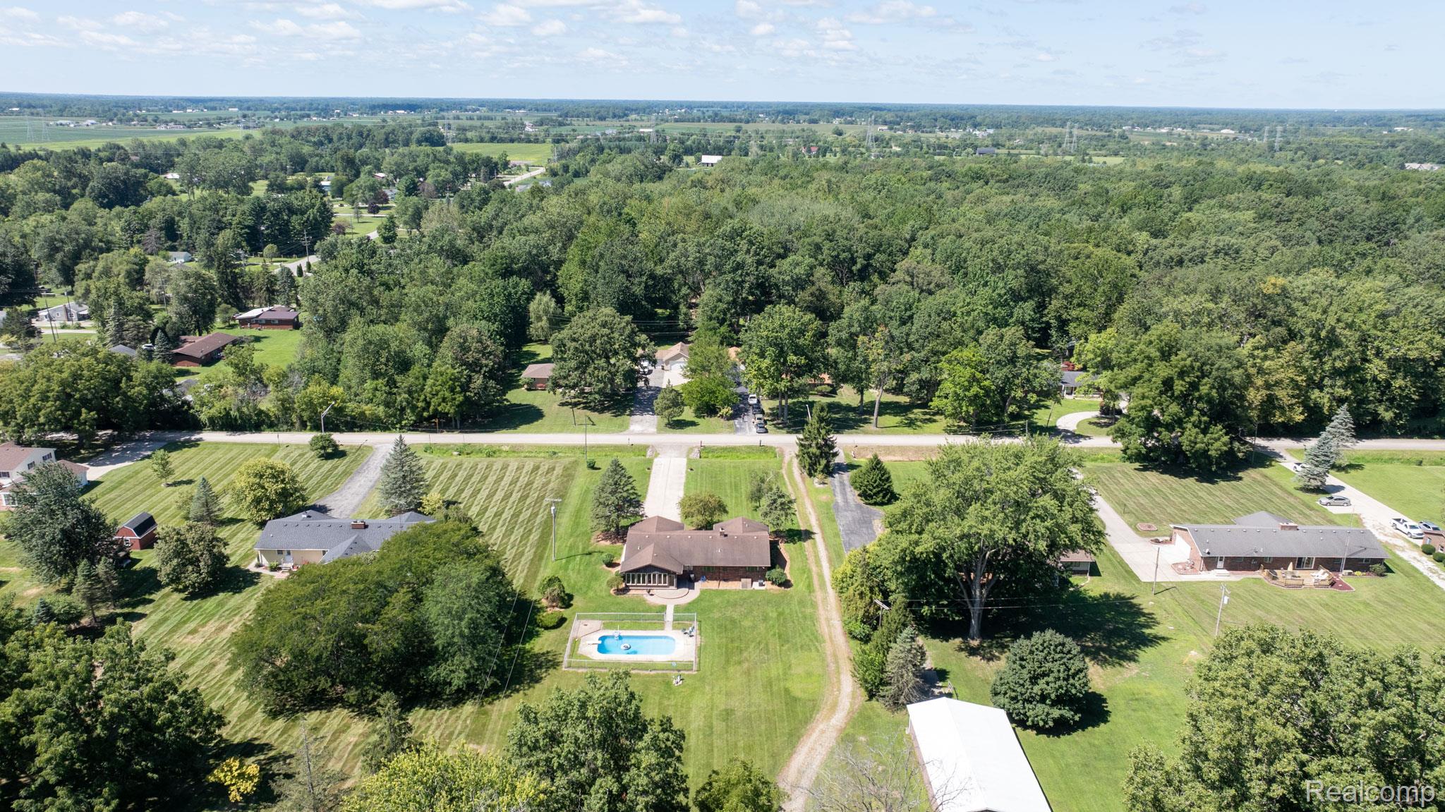 12900 Maxwell Road Carleton, MI 48117 - Photo 15 of 59 Expansive property featuring a private swimming pool, mature trees, and a detached building