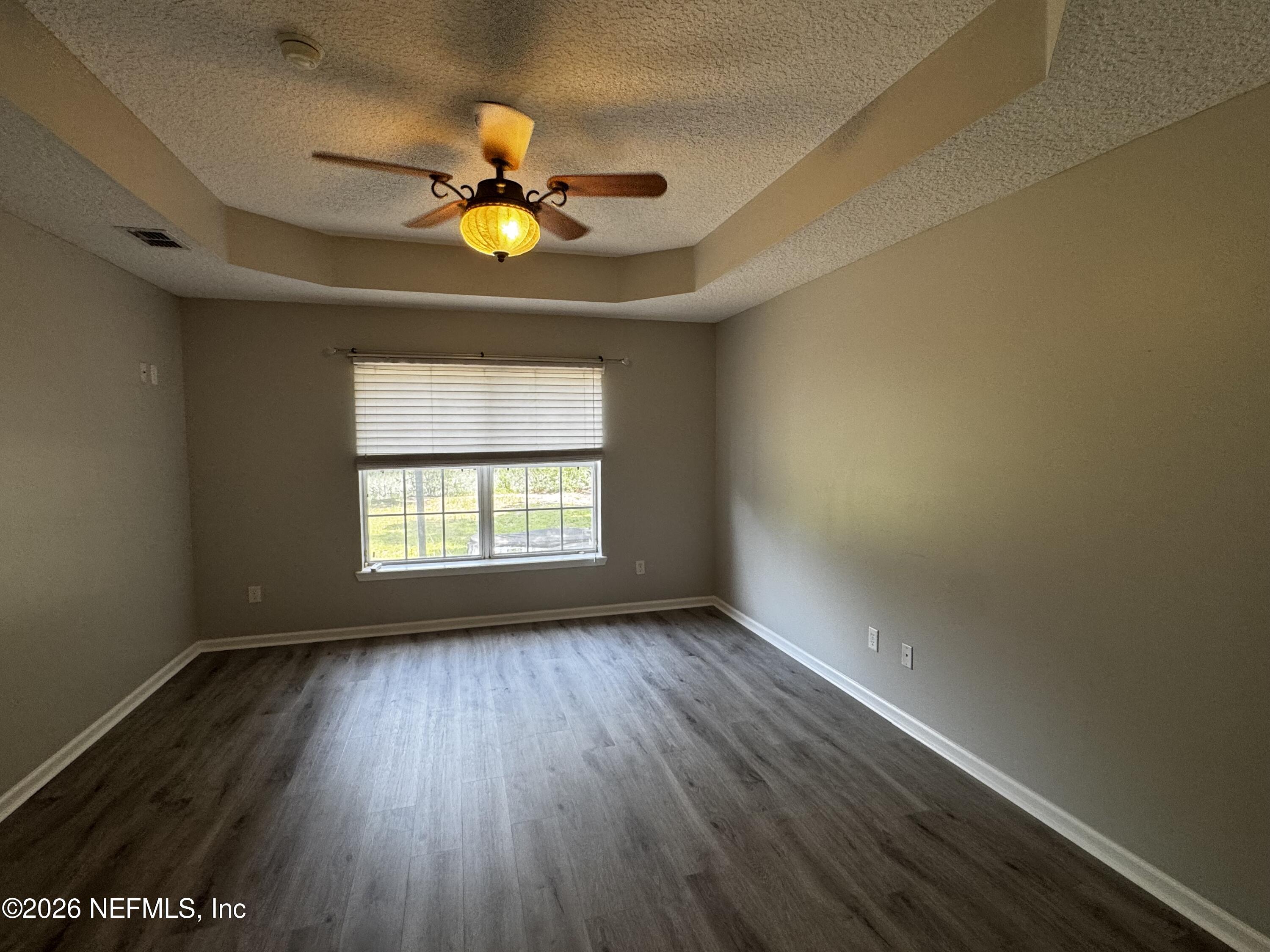 16255 Shellcracker Road Jacksonville, FL 32226 - Photo 13 of 40 a view of an empty room with window and wooden floor