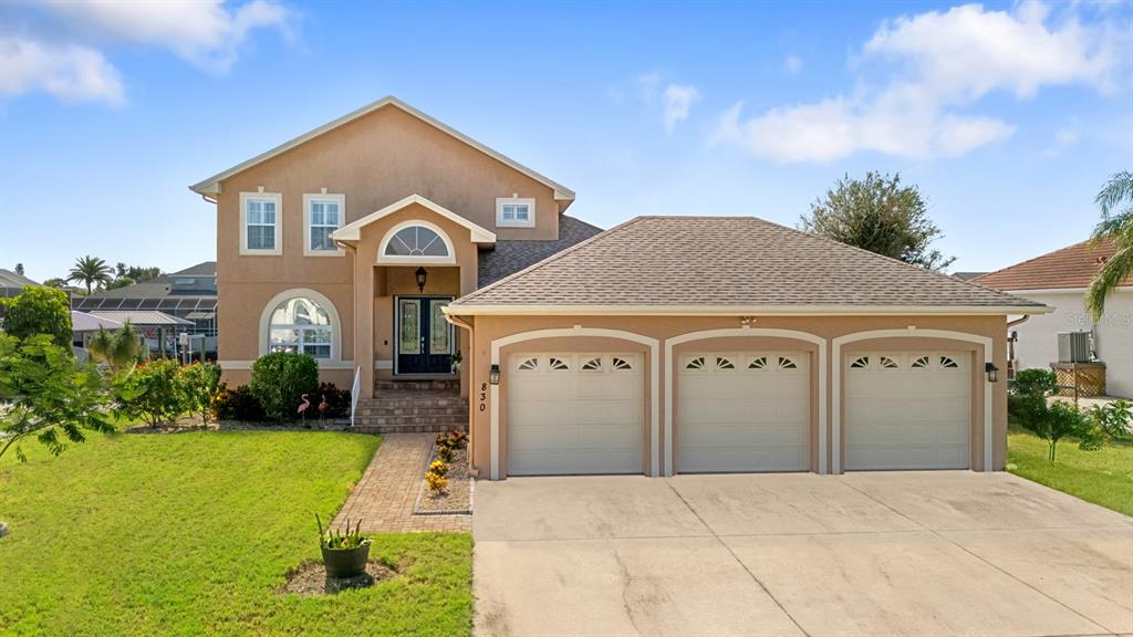 830 Golf Island Drive Apollo Beach, FL 33572 - Photo 2 of 87 a front view of a house with garden