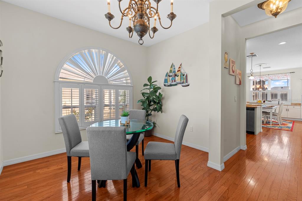 830 Golf Island Drive Apollo Beach, FL 33572 - Photo 26 of 87 a view of a dining room with furniture wooden floor and chandelier