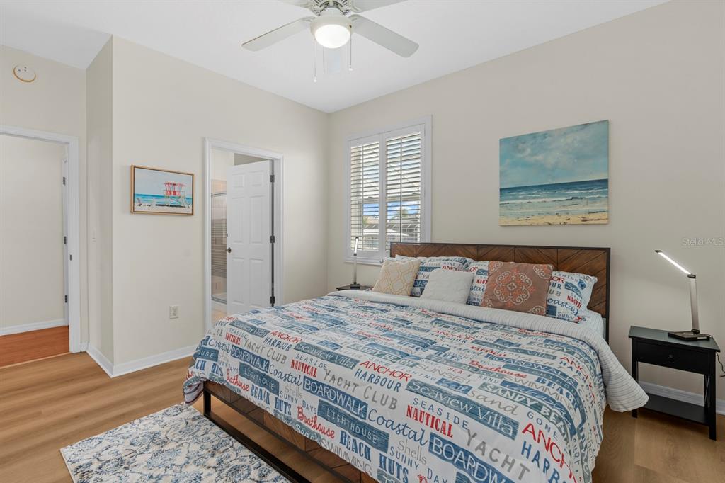 830 Golf Island Drive Apollo Beach, FL 33572 - Photo 40 of 87 a bedroom with a bed and a chandelier