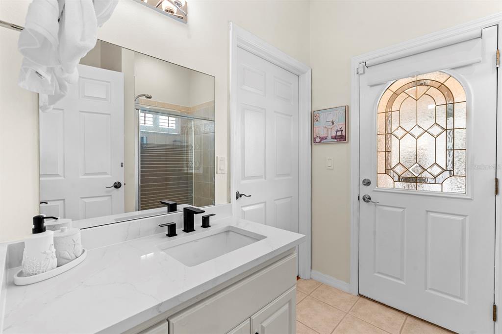 830 Golf Island Drive Apollo Beach, FL 33572 - Photo 41 of 87 a bathroom with a sink a mirror and next to a window