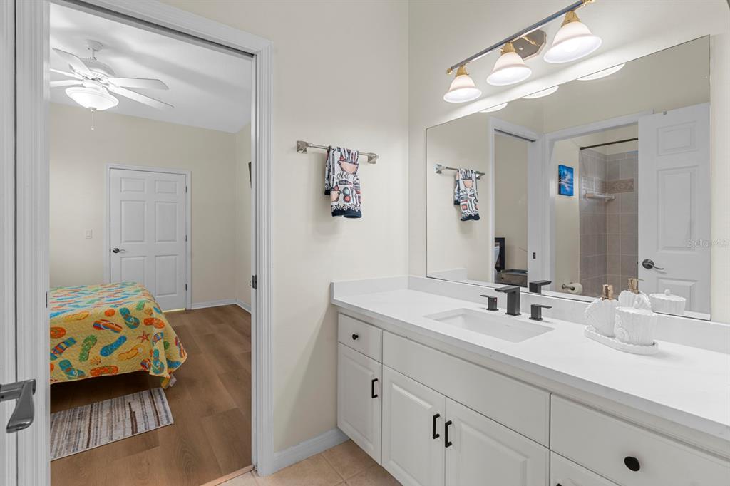 830 Golf Island Drive Apollo Beach, FL 33572 - Photo 45 of 87 a en suite bathroom with double sink and a mirror