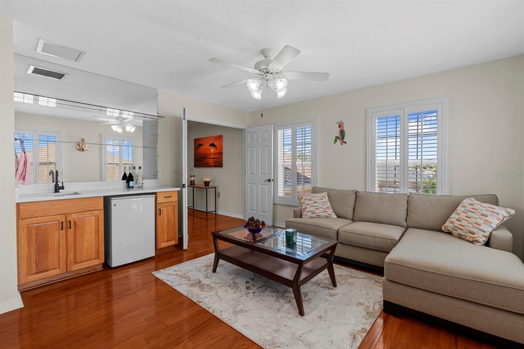 830 Golf Island Drive Apollo Beach, FL 33572 - Photo 55 of 87 a living room with furniture a wooden floor and a sink