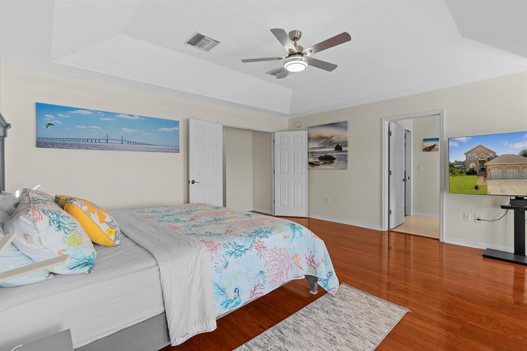 830 Golf Island Drive Apollo Beach, FL 33572 - Photo 56 of 87 a bedroom with a bed and a chandelier