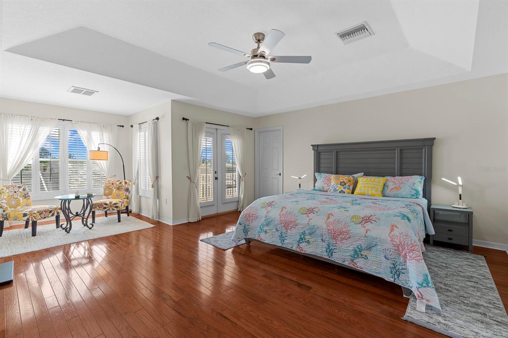 830 Golf Island Drive Apollo Beach, FL 33572 - Photo 57 of 87 a bedroom with a bed and a table with wooden floor