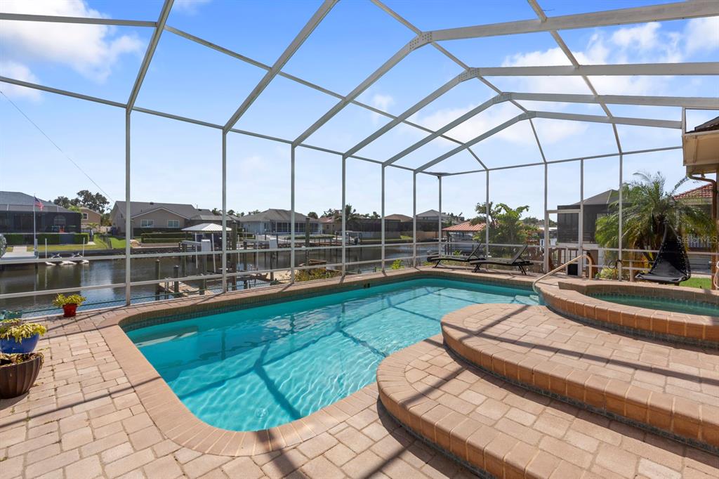 830 Golf Island Drive Apollo Beach, FL 33572 - Photo 73 of 87 a view of a swimming pool with a lounge chairs