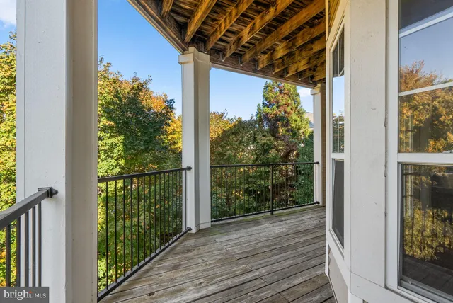 a view of a balcony with wooden floor