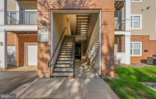 a view of a brick house with many windows