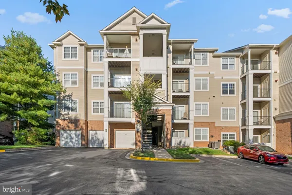a front view of a residential apartment building with a yard