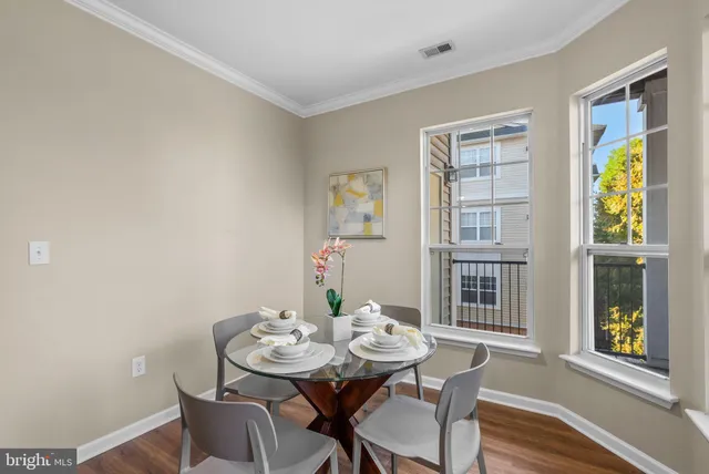 a view of a dining room with furniture and a window