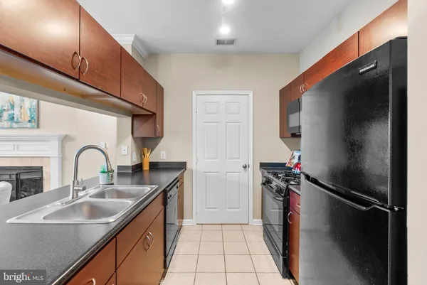 a kitchen with a sink a refrigerator and a stove