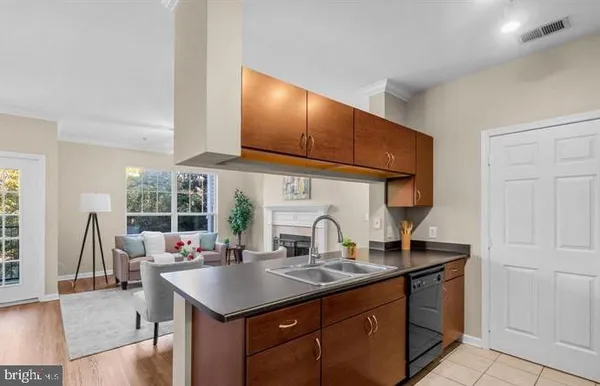 a kitchen with a stove a sink and a wooden cabinets