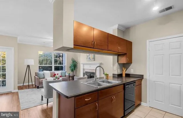 a kitchen with a stove a sink and a wooden cabinets