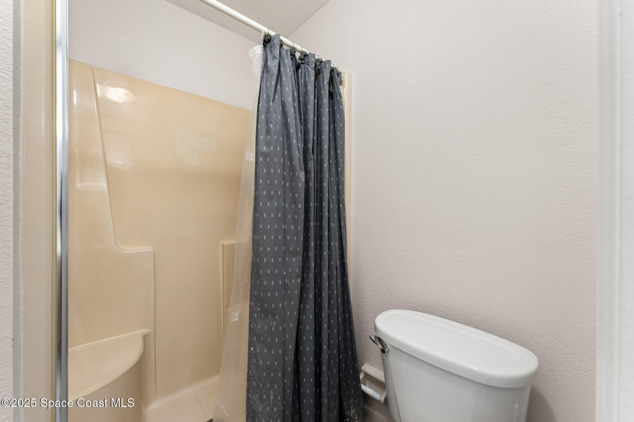129 Seawind Drive, Unit 25 Satellite Beach, FL 32937 - Photo 12 of 28 a white toilet sitting next to a bathroom sink
