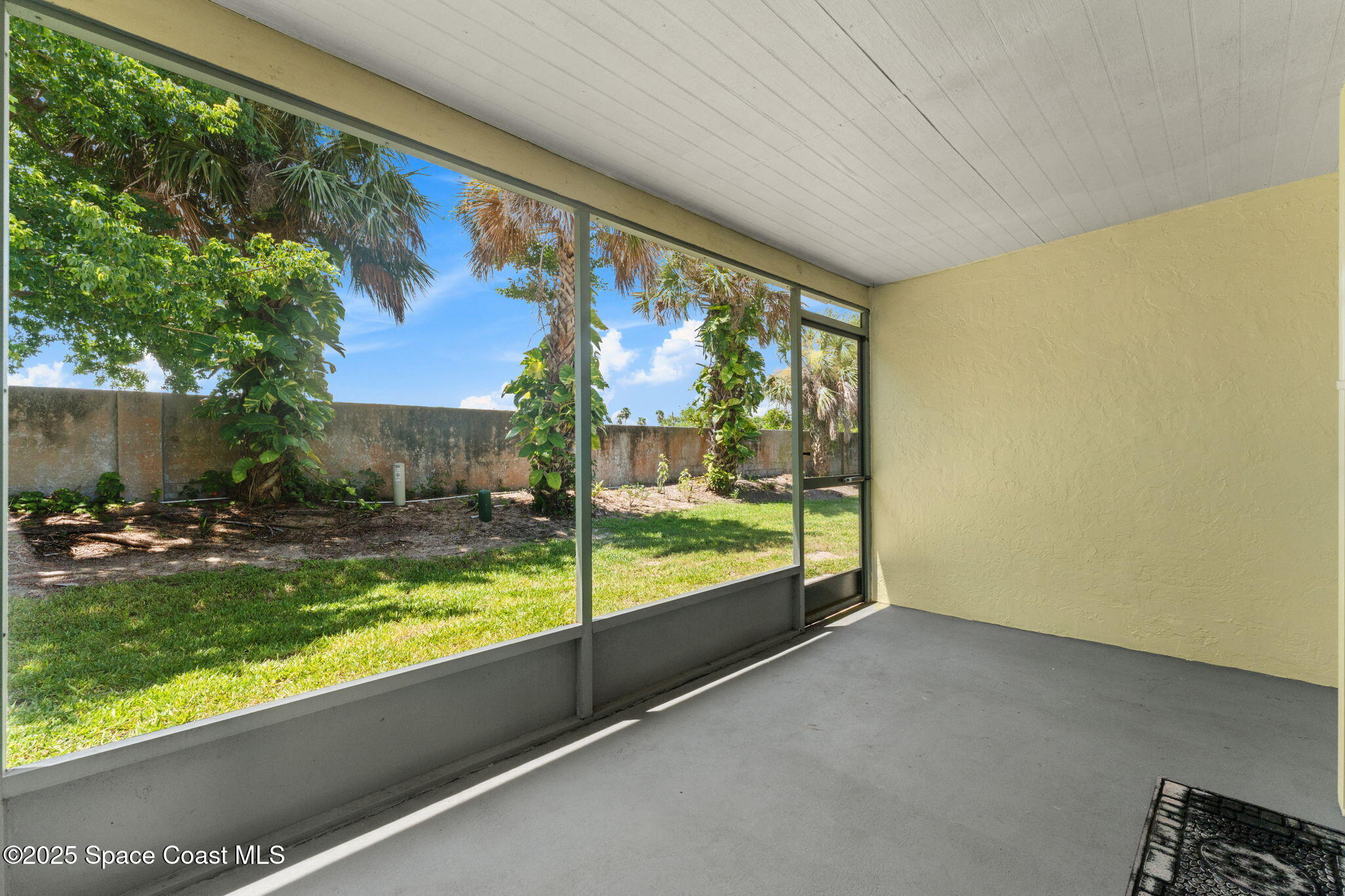 129 Seawind Drive, Unit 25 Satellite Beach, FL 32937 - Photo 17 of 28 a view of backyard with garden and patio