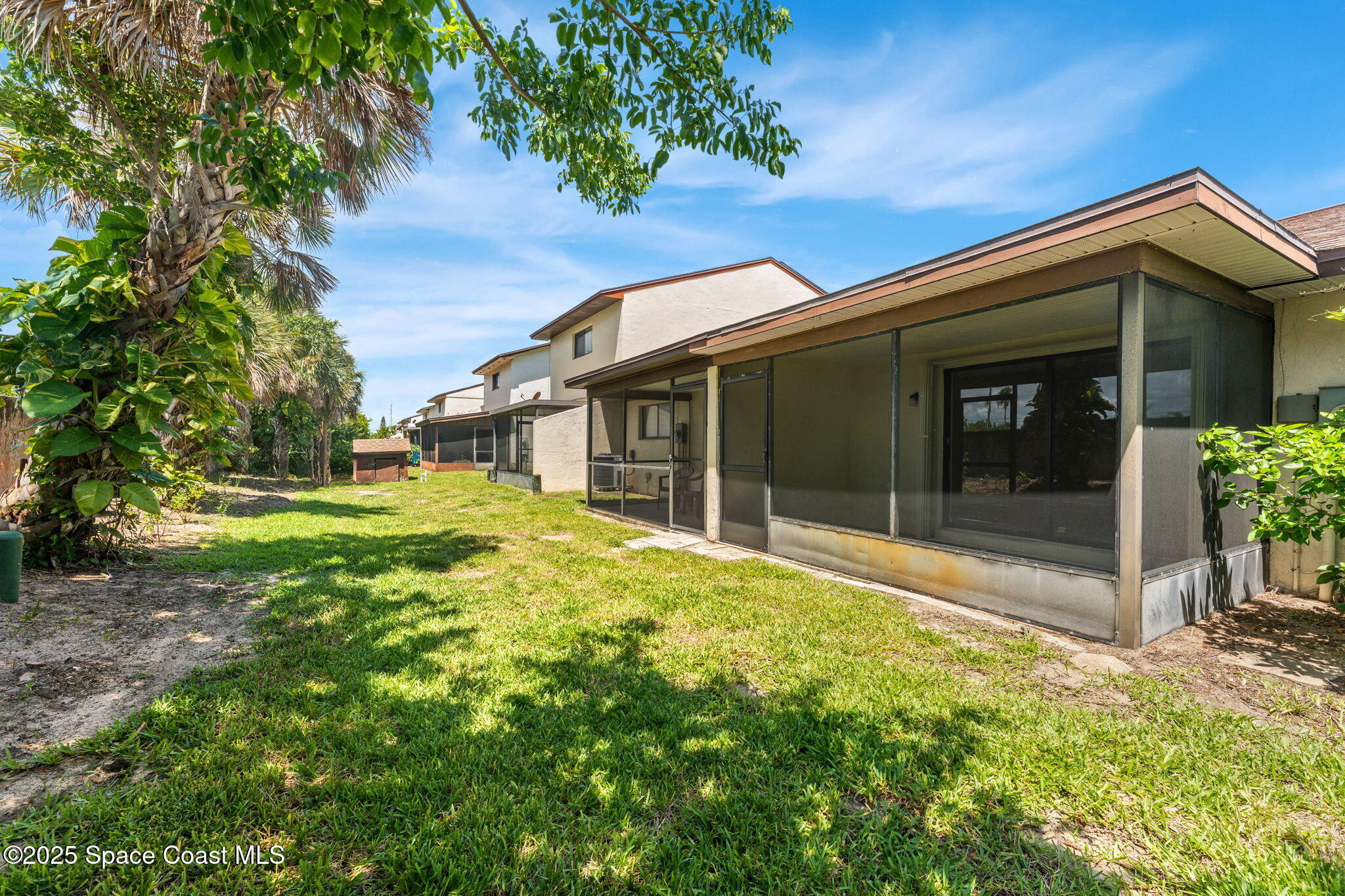 129 Seawind Drive, Unit 25 Satellite Beach, FL 32937 - Photo 19 of 28 a view of a house with a small yard