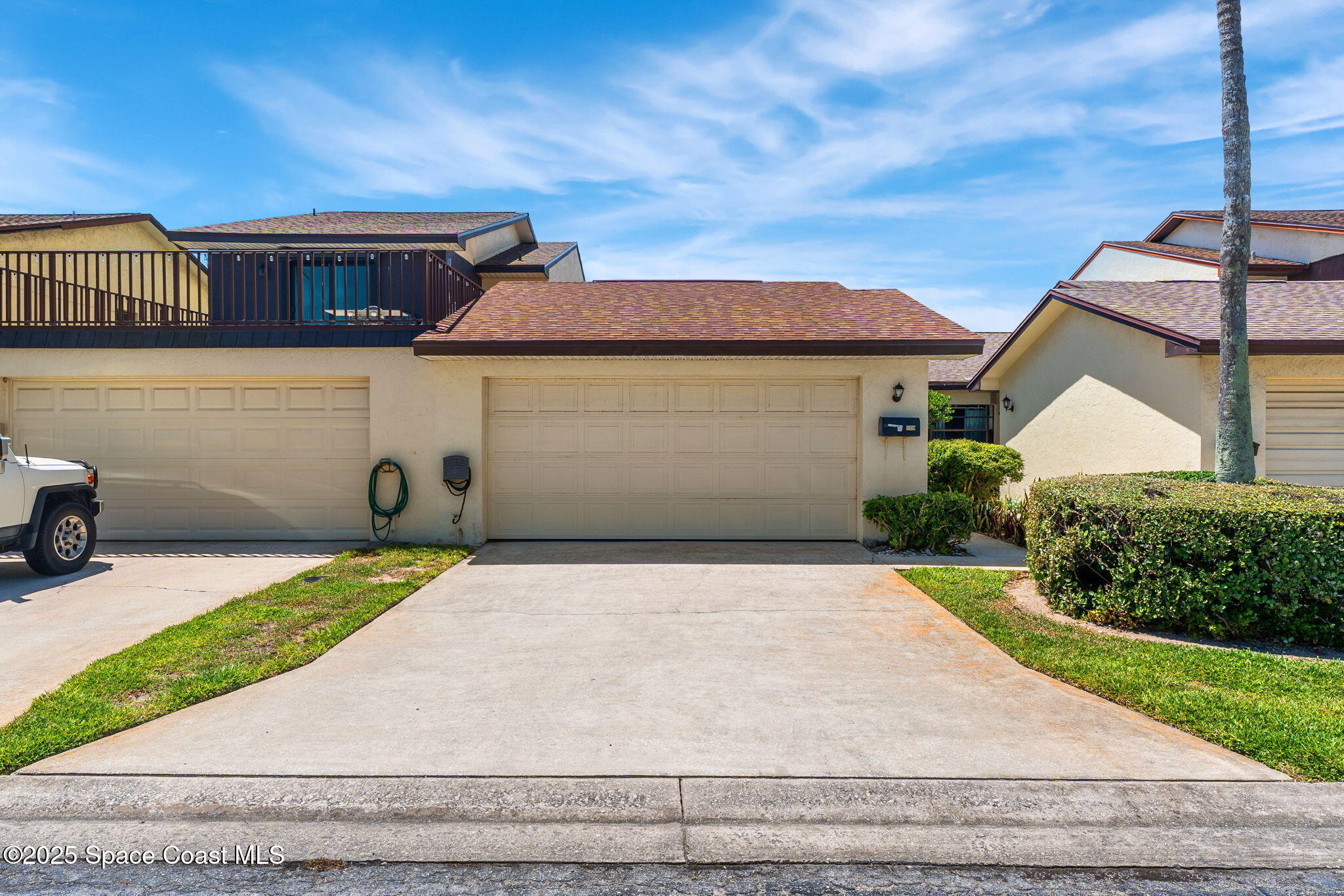 129 Seawind Drive, Unit 25 Satellite Beach, FL 32937 - Photo 20 of 28 a front view of a house with a garden