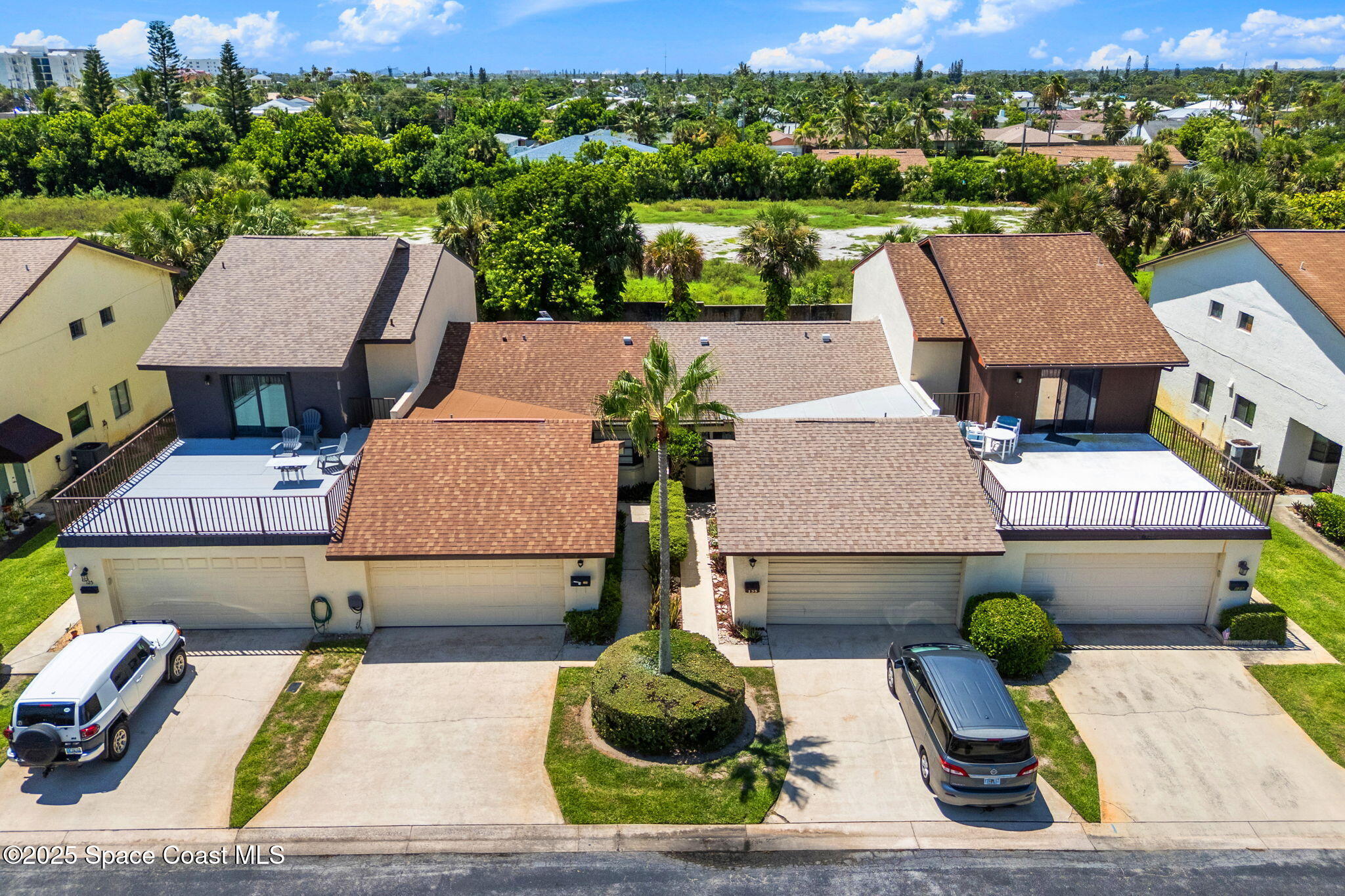 129 Seawind Drive, Unit 25 Satellite Beach, FL 32937 - Photo 21 of 28 an aerial view of a house with large garden and plants