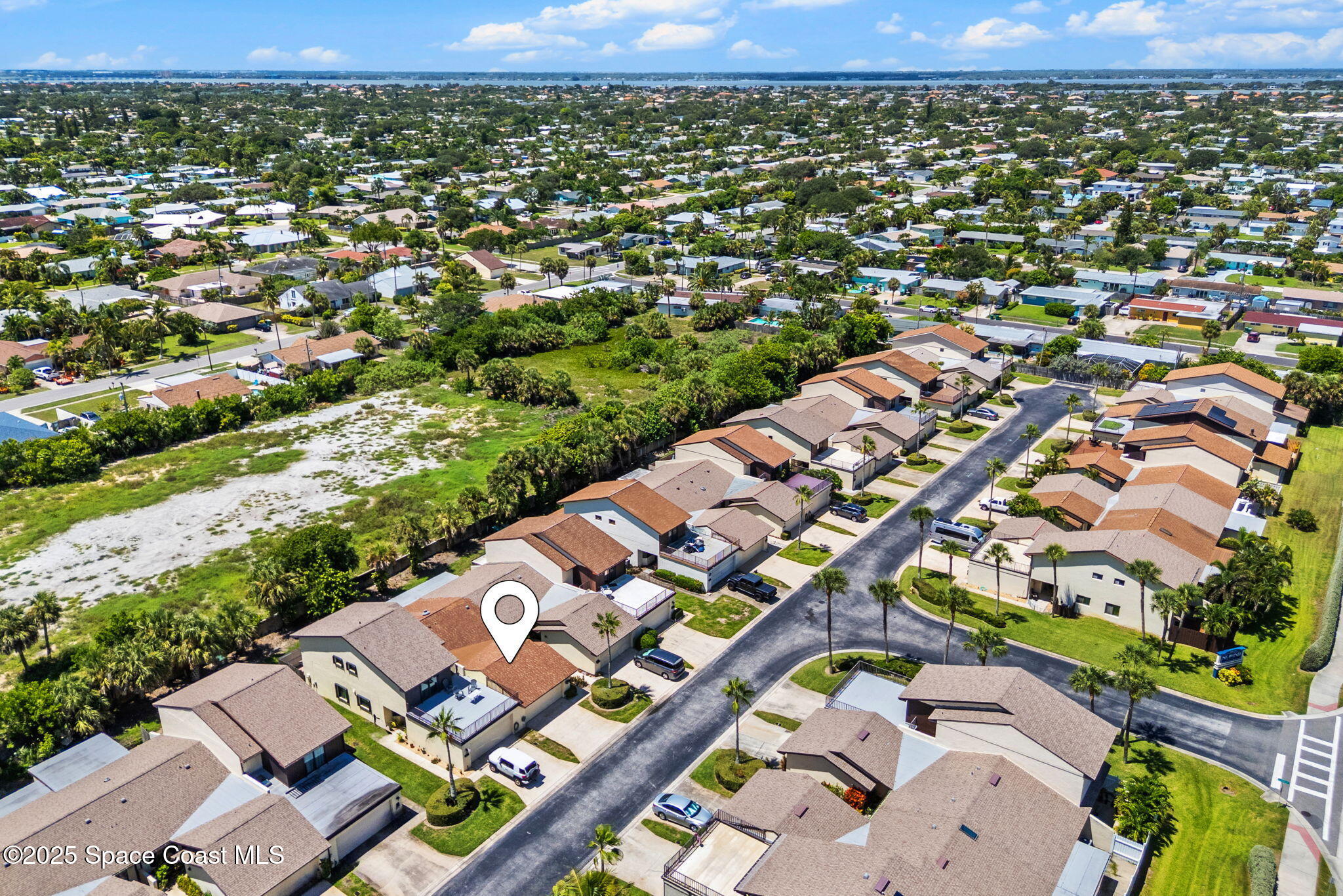 129 Seawind Drive, Unit 25 Satellite Beach, FL 32937 - Photo 25 of 28 an aerial view of a city with lots of residential buildings