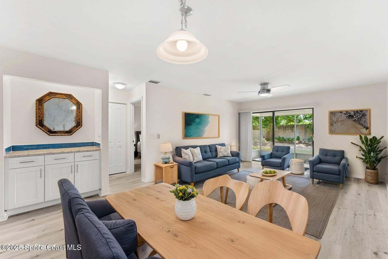 129 Seawind Drive, Unit 25 Satellite Beach, FL 32937 - Photo 5 of 28 a living room with furniture a fireplace and a large window