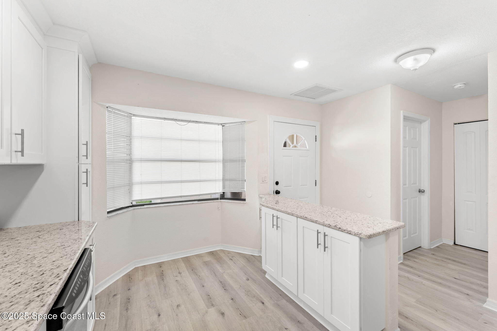 129 Seawind Drive, Unit 25 Satellite Beach, FL 32937 - Photo 7 of 28 a view of an empty room with wooden floor