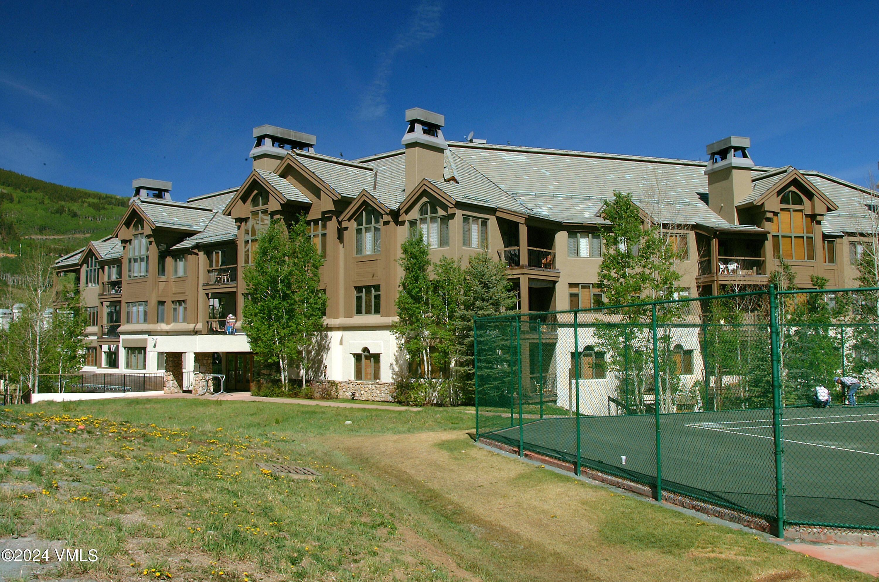 15 Highlands Lane, Unit R407 Beaver Creek, CO 81620 - Photo 14 of 18 a front view of a house with a garden