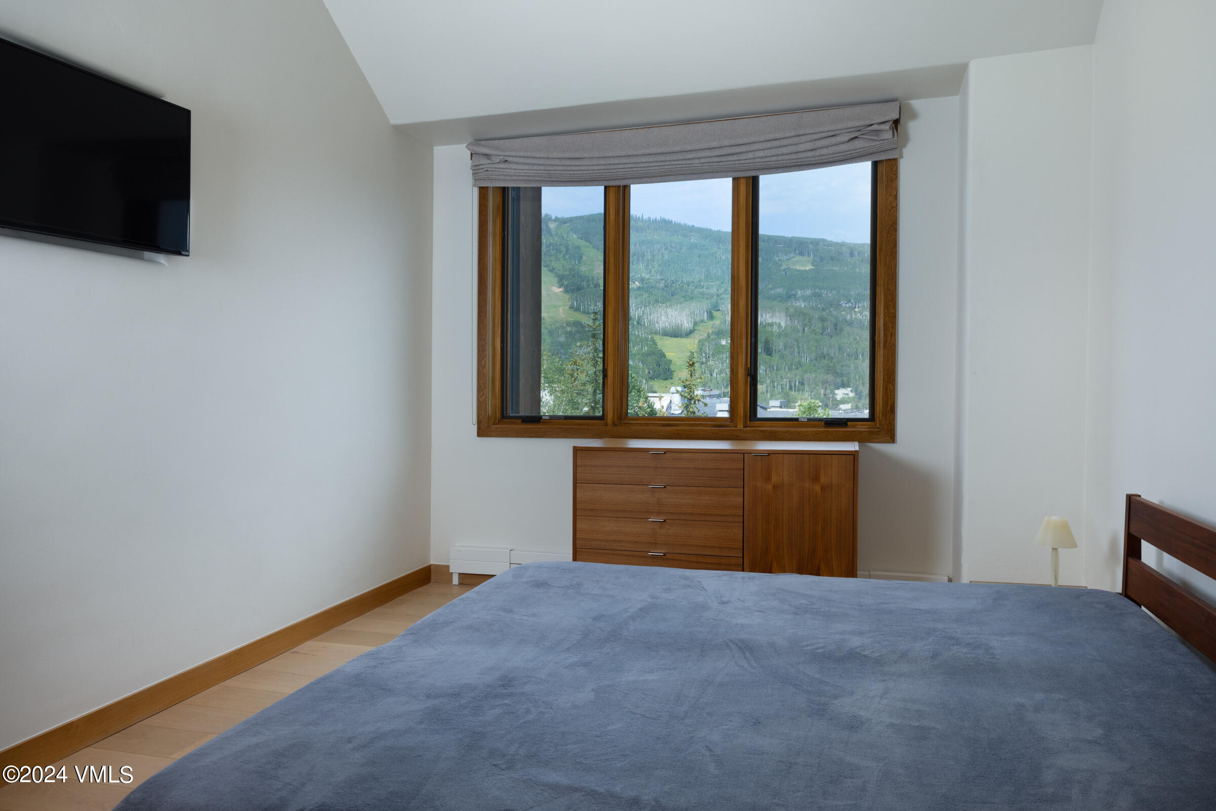 15 Highlands Lane, Unit R407 Beaver Creek, CO 81620 - Photo 7 of 18 a view of an empty room with a window and a flat screen tv