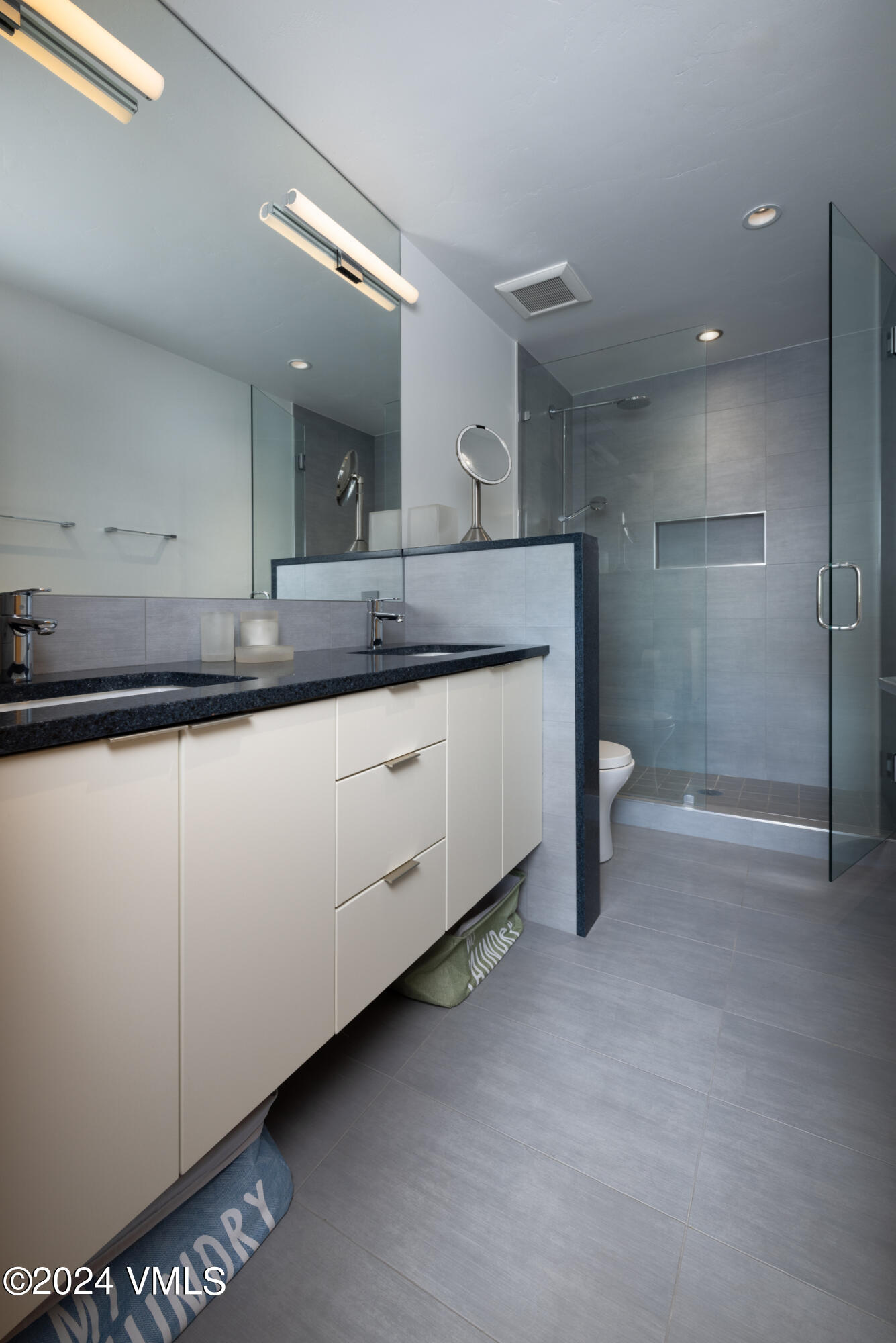 15 Highlands Lane, Unit R407 Beaver Creek, CO 81620 - Photo 8 of 18 a bathroom with a sink a toilet and a mirror