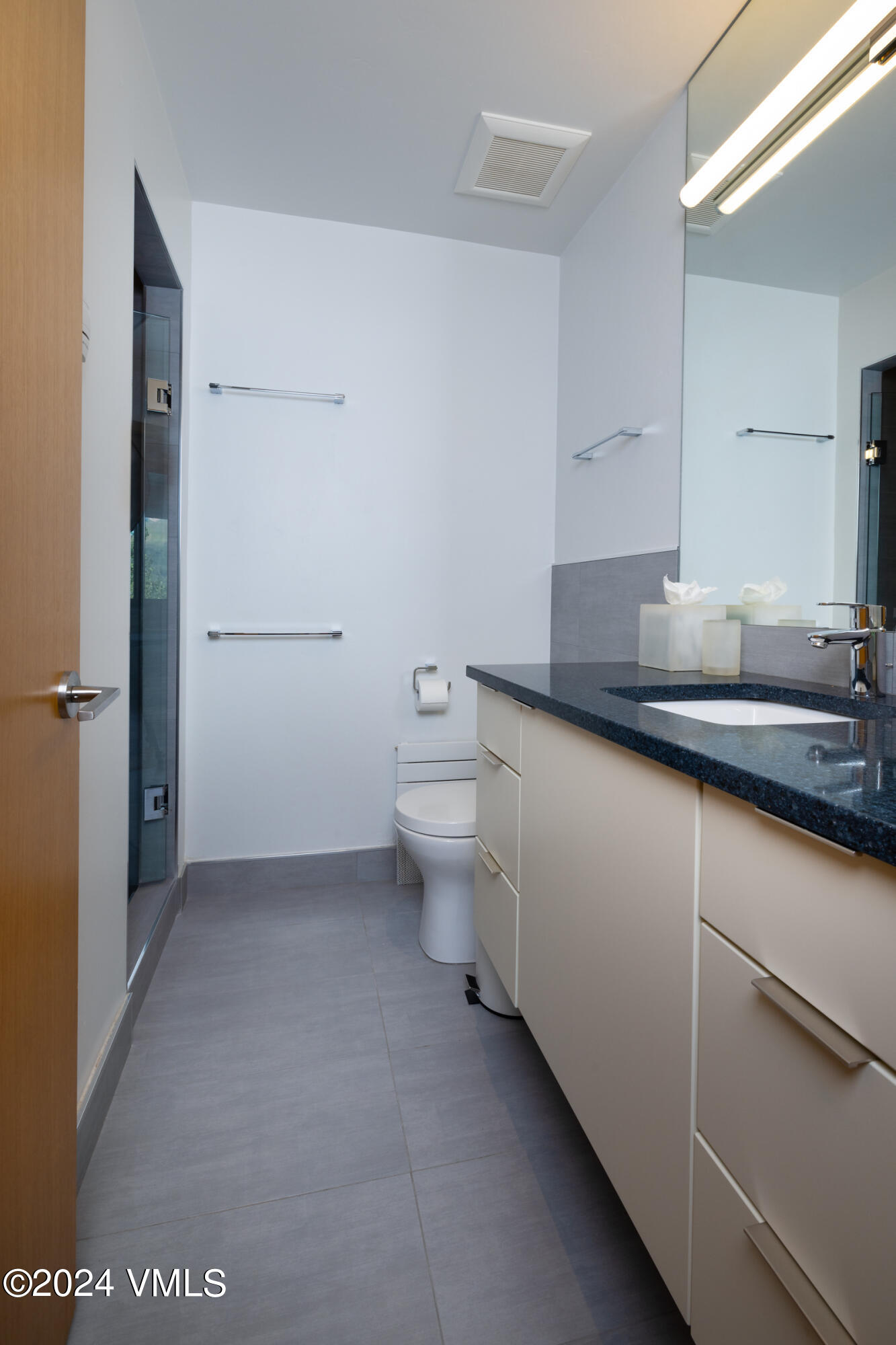 15 Highlands Lane, Unit R407 Beaver Creek, CO 81620 - Photo 10 of 18 a bathroom with a granite countertop sink a toilet and a mirror