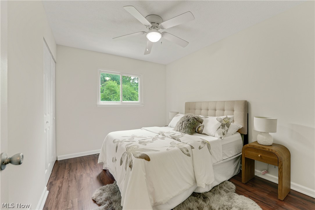 646 Ledge Road Macedonia, OH 44056 - Photo 11 of 28 Bright room featuring wood-finish flooring, a contemporary ceiling fan with integrated lighting, and a window framing lush greenery