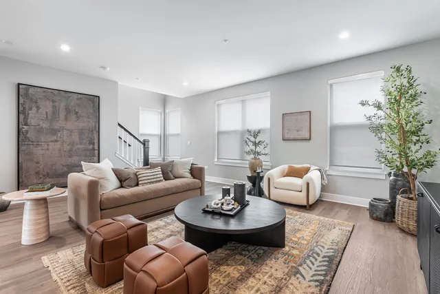 a living room with furniture a flat screen tv and a large window