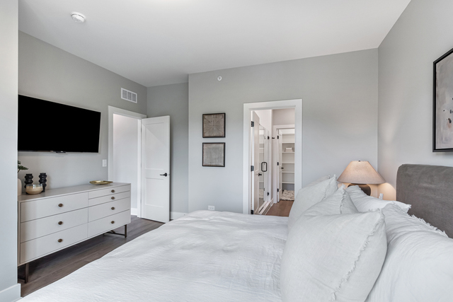 5424 Old Orchard Road Skokie, IL 60077 - Photo 21 of 56 a bedroom with a bed and a flat screen tv