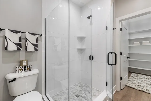 a view of walk in closet with clothes and shoes