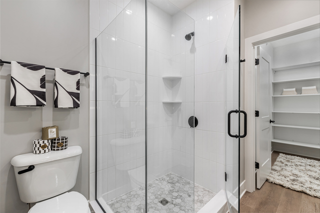 5424 Old Orchard Road Skokie, IL 60077 - Photo 22 of 56 a bathroom with a granite countertop shower a toilet and sink