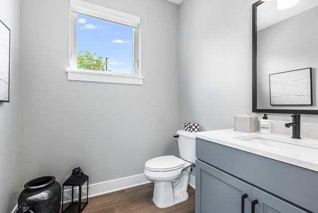 5424 Old Orchard Road Skokie, IL 60077 - Photo 32 of 56 a bathroom with a toilet a sink and mirror