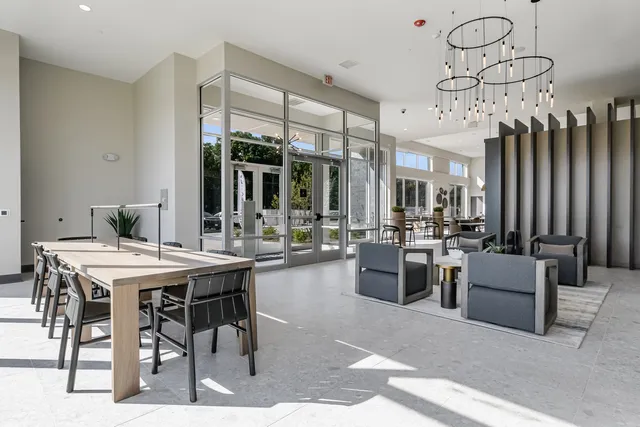 a outdoor space with lots of tables a large mirror and chairs