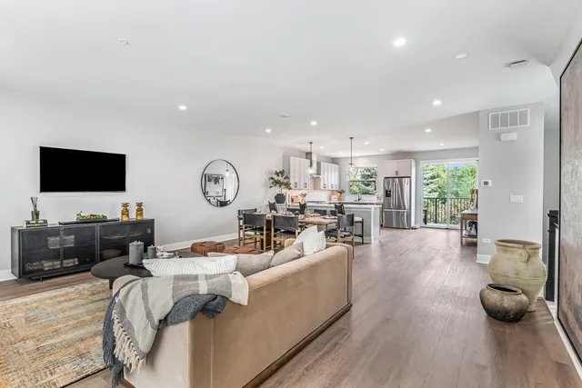a large kitchen with lots of counter space dining table and stainless steel appliances