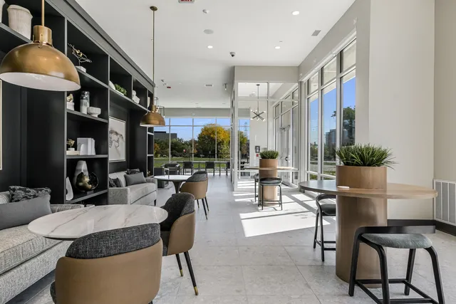 a living room with furniture a flat screen tv and kitchen view