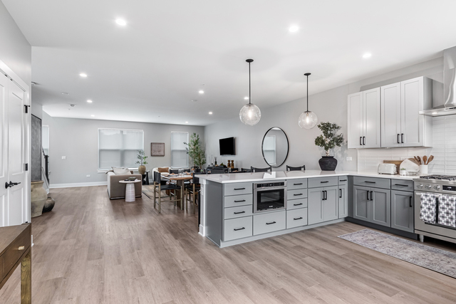 5424 Old Orchard Road Skokie, IL 60077 - Photo 5 of 56 a large kitchen with lots of counter space dining table and stainless steel appliances