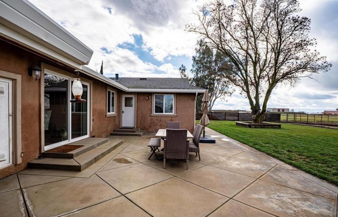 18393 Paradise Road Tracy, CA 95304 - Photo 19 of 36 a view of a house with backyard sitting area and garden