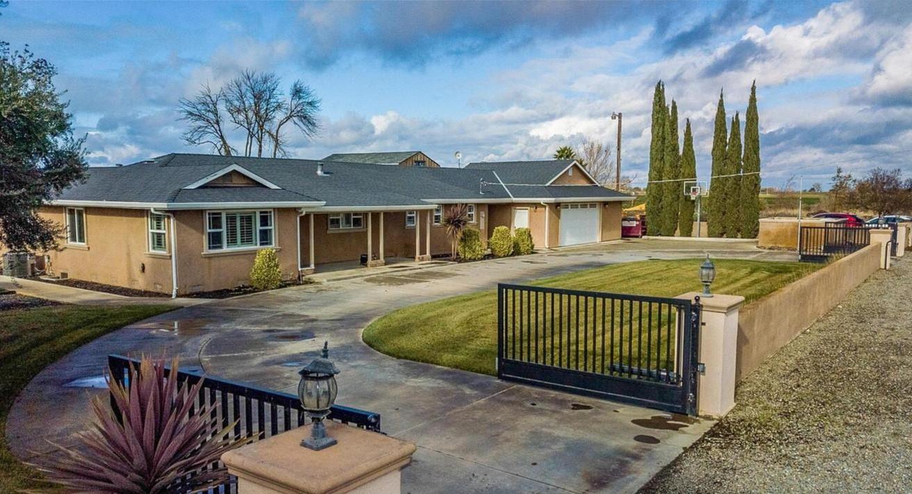 18393 Paradise Road Tracy, CA 95304 - Photo 2 of 36 a view of a house with a wooden deck and a yard