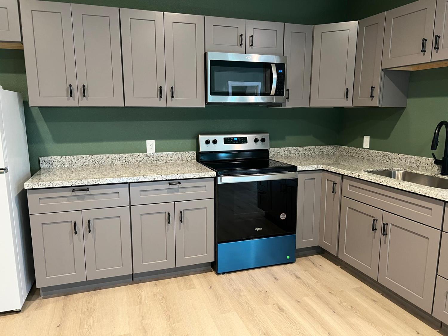 18393 Paradise Road Tracy, CA 95304 - Photo 27 of 36 a kitchen with cabinets appliances and a sink