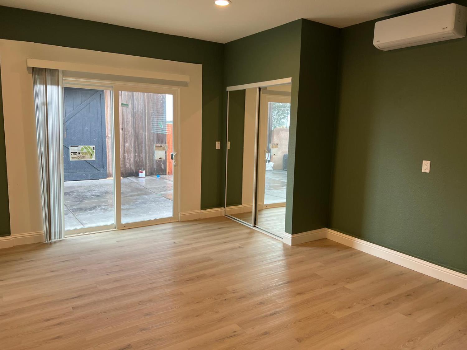 18393 Paradise Road Tracy, CA 95304 - Photo 28 of 36 a view of an empty room with wooden floor and a window