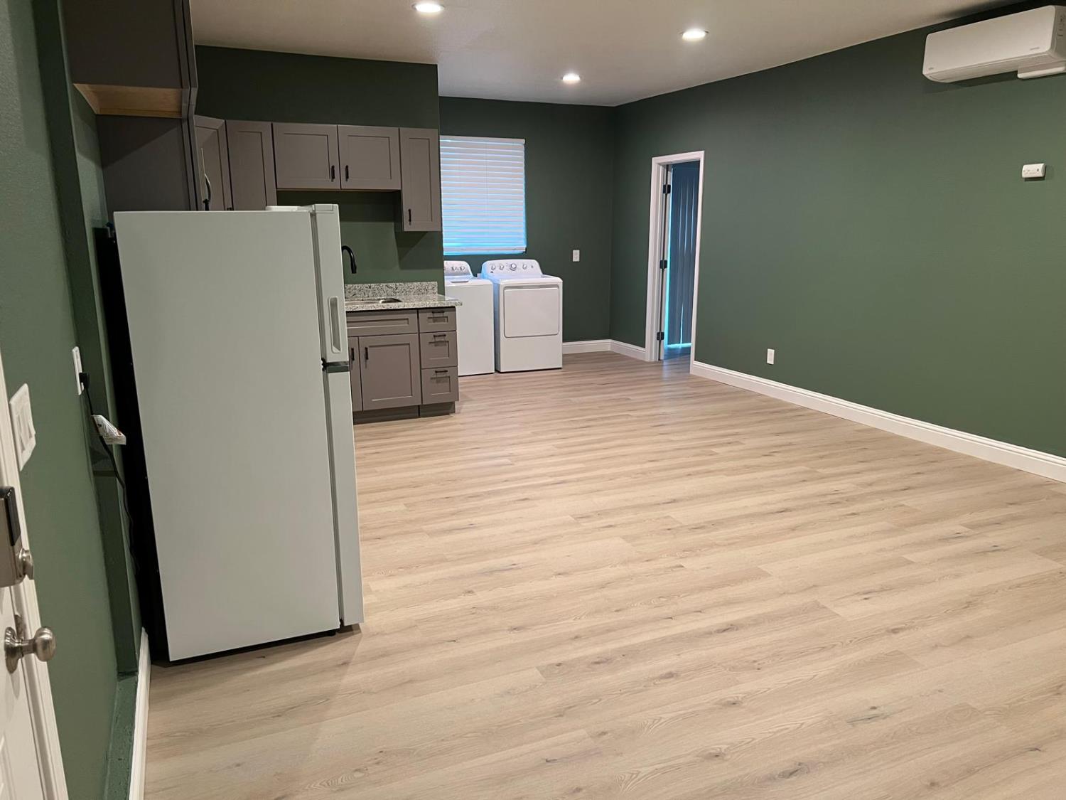 18393 Paradise Road Tracy, CA 95304 - Photo 35 of 36 a kitchen with stainless steel appliances a refrigerator and wooden floor