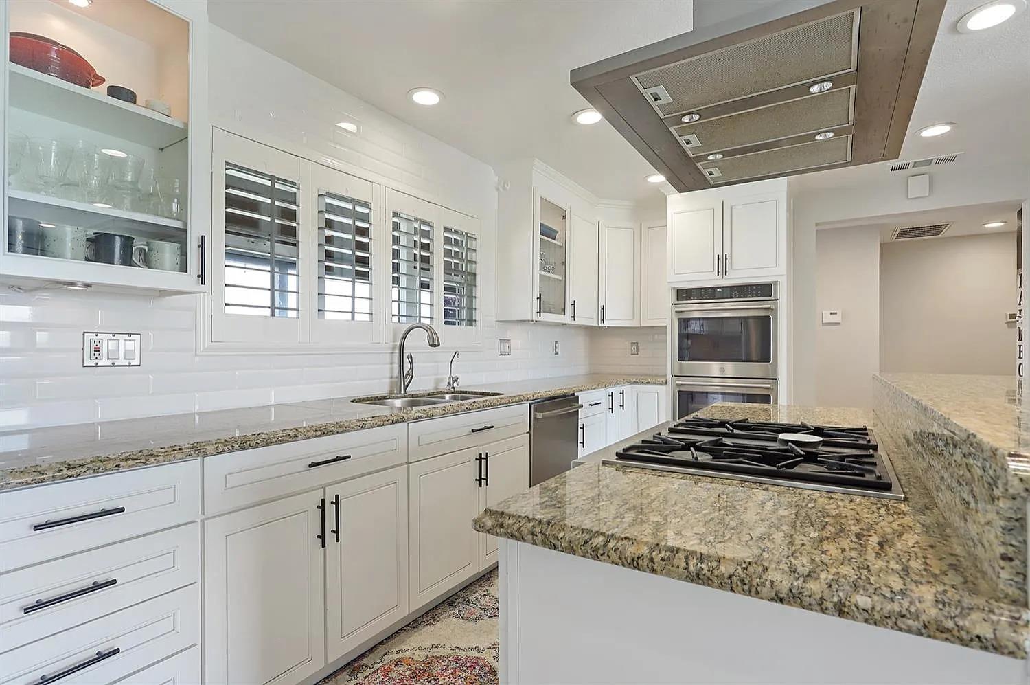 18393 Paradise Road Tracy, CA 95304 - Photo 4 of 36 a kitchen with stainless steel appliances granite countertop a stove sink and cabinets