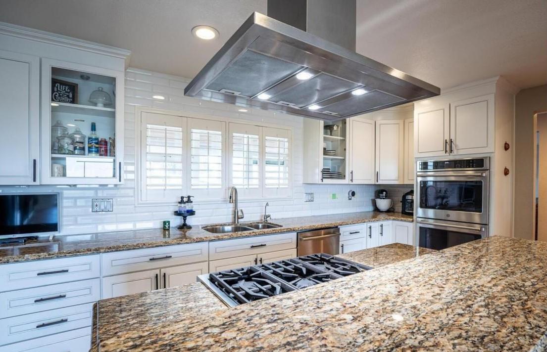 18393 Paradise Road Tracy, CA 95304 - Photo 6 of 36 a kitchen with stainless steel appliances kitchen island granite countertop a sink stove cabinets and refrigerator
