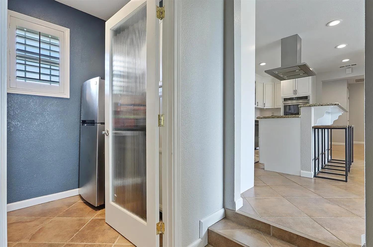 18393 Paradise Road Tracy, CA 95304 - Photo 7 of 36 a view of a hallway with wooden floor and staircase